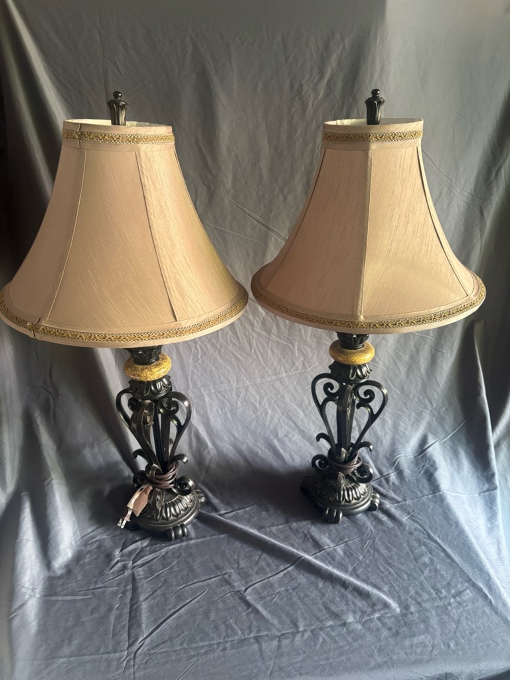 Scrolling metal lamp with stone finial